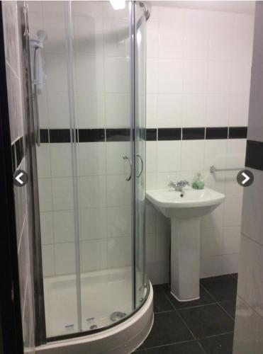 a bathroom with a shower and a sink at Nights Inn in Slough