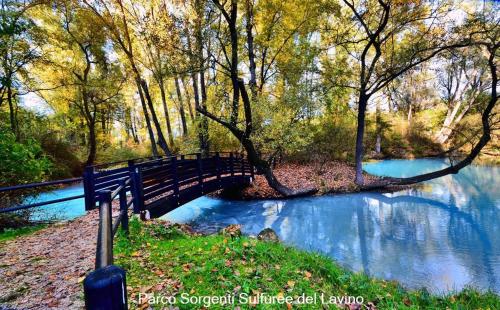 a bridge over a river with trees and water at Dannunziano Aparthotel in Chieti