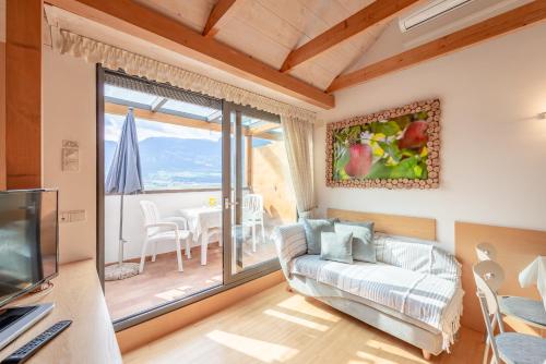 a living room with a couch and a tv at Haus Piger in Termeno