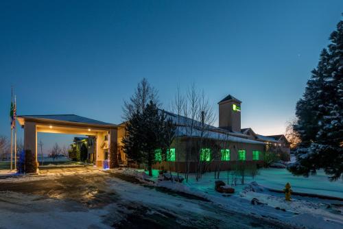 a building with green lights on it at night at Holiday Inn Express Hotel & Suites Raton by IHG in Raton