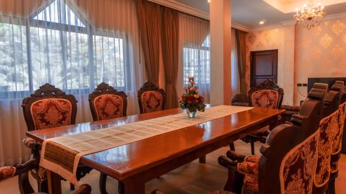 a conference room with a large wooden table and chairs at LAOTEL VIENTIANE in Vientiane