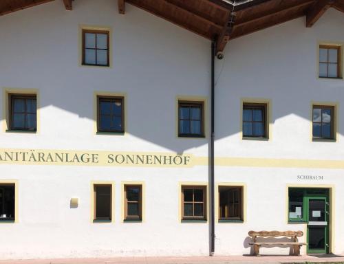 a building with a bench in front of it at Zillerglückhütte - 5 Sterne Camping Aufenfeld in Aschau