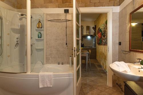 a bathroom with a shower and a tub and a sink at B&B IL Cammino in Lanciano