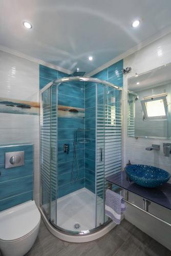 a bathroom with a shower with a toilet and a sink at Golden View Studios in Chrysi Ammoudia