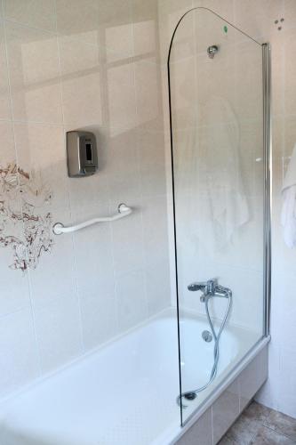 a shower stall with a glass shower door at Hotel Maruxa in A Lanzada