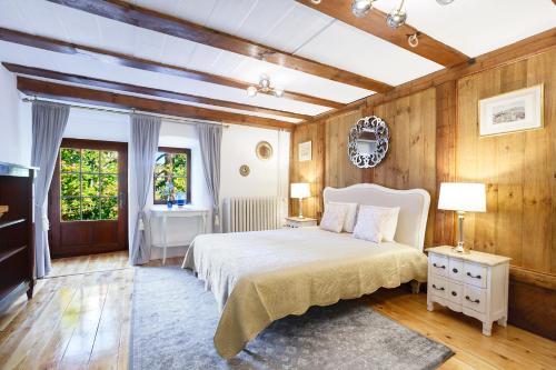 a bedroom with a white bed and wooden walls at A castle spirit apartment in Château du Châtelard in Clarens