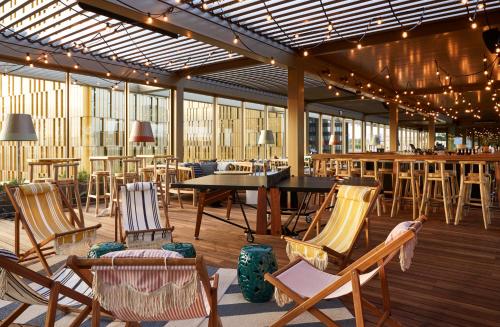 a patio with chairs and a table and a bar at Mama Shelter Luxembourg in Luxembourg