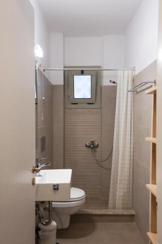 a bathroom with a toilet and a sink and a shower at Maistrali in Livadion