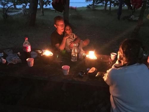 a group of people sitting around a table with candles at Villa Wiegand - a room with a view in Holbæk