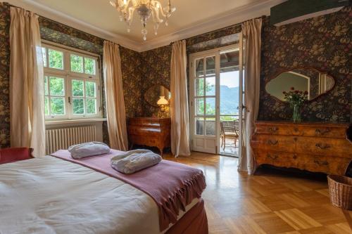 a bedroom with a bed and a large mirror at Ronco Dell'Abate - Lake Como Relais B&B in Como