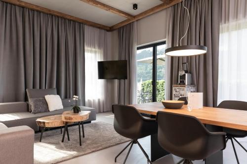 a living room with a dining table and a couch at GOING TRIPLE A apartments EAST in Going