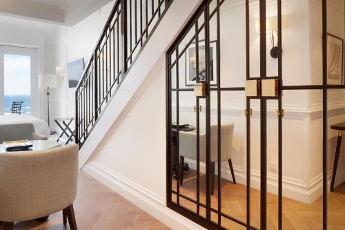 a room with a staircase with a glass wall at Hotel Boutique Villa Favorita in Donostia-San Sebastián