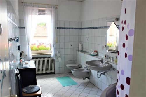 a bathroom with a toilet and a sink at Hotel zur Post Schwanheim in Frankfurt/Main