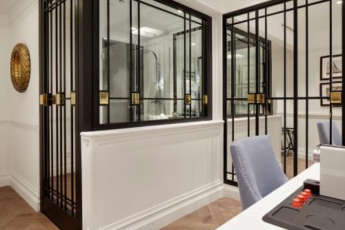 an office with glass doors and a desk with a computer at Hotel Boutique Villa Favorita in Donostia-San Sebastián