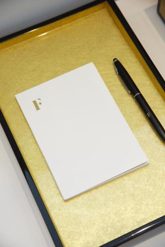 a pen and a piece of paper on a table at Hotel Boutique Villa Favorita in Donostia-San Sebastián