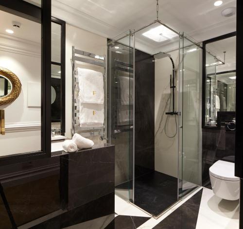 a bathroom with a glass shower and a toilet at Hotel Boutique Villa Favorita in Donostia-San Sebastián