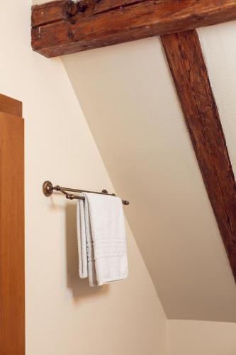 a towel rack with a white towel hanging on a wall at Hotel Am Ring in Sibiu