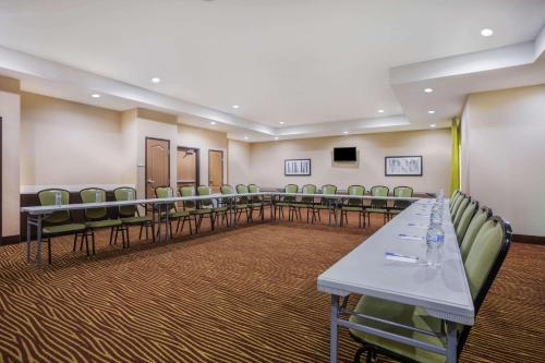 a conference room with a long table and chairs at La Quinta by Wyndham Beeville in Beeville