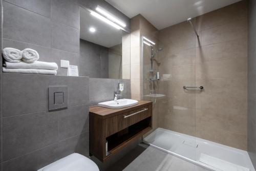 a bathroom with a toilet and a sink and a shower at DB Hotel Wrocław in Wrocław