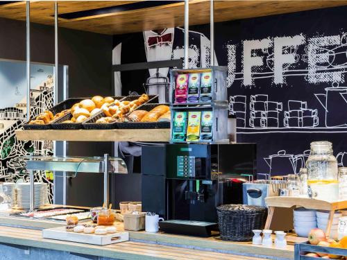 a bakery counter with pastries and other food items at ibis Budget Knokke in Knokke-Heist