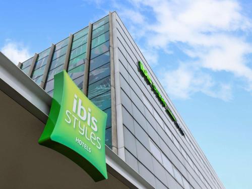 a green and white sign on a building at ibis Styles Amsterdam Airport in Schiphol