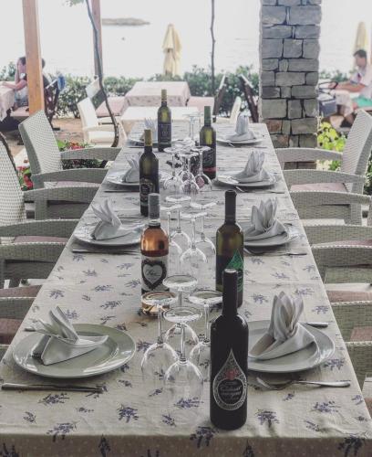 a long table with wine bottles and glasses on it at Lavanda Mobile Homes & Villas in Orebić