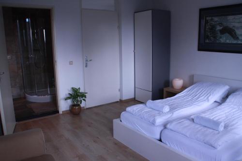 a white room with a bed and a shower at Floriande Stay in Hoofddorp