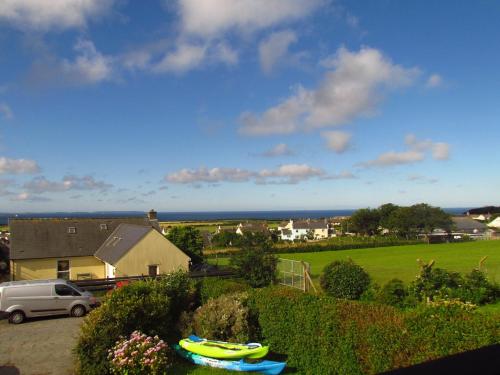 a yellow boat on a table in front of a house at Ty Aelwyd in St. Davids
