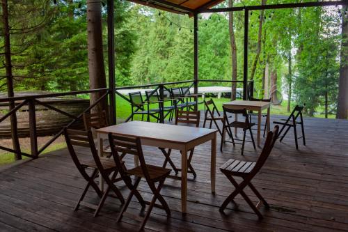 a group of tables and chairs on a deck at Berta Village in Buzharovo
