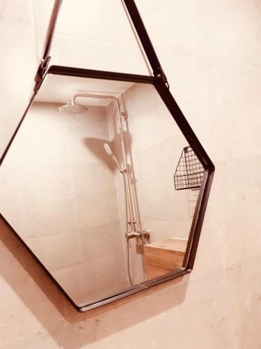 a mirror hanging on the wall of a shower at Villa Río Mielno in Mielno