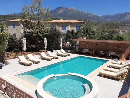 a swimming pool with lounge chairs and a piano at Athina Apartments in Stoupa