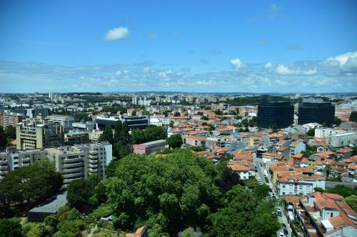 a city with tall buildings and a sky background at Porto Palácio Hotel by The Editory in Porto