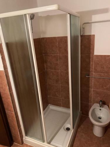 a shower stall in a bathroom with a toilet at Bellagio Apartment in Bellagio