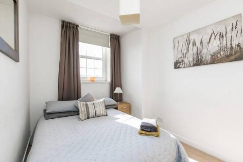 a bedroom with a bed and a window at Flat 34 Fraser house apartment city centre apartment in Aberdeen