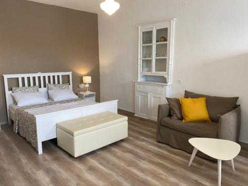 a bedroom with a bed and a couch at Thodoris Infinity View Apartments in Symi