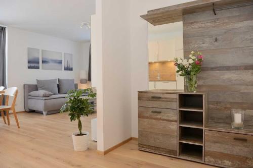 a living room with a wooden wall with a dresser at Apartment Olperer in Mühlbachl
