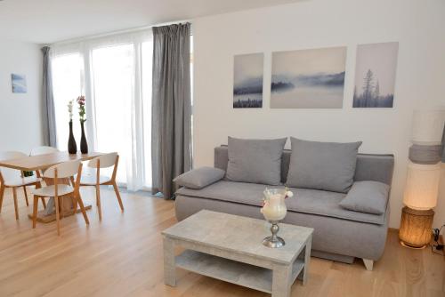 a living room with a couch and a table at Apartment Olperer in Mühlbachl
