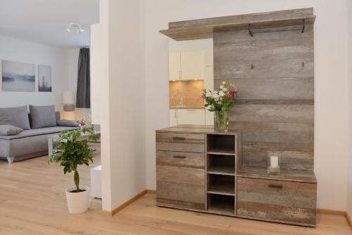 a living room with a wooden wall with a dresser at Apartment Olperer in Mühlbachl