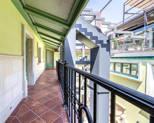 a corridor of a building with a balcony at Oysters & Bubbles Gastro Hotel. Rynok square in Lviv