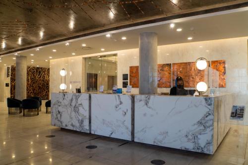 a lobby with a marble counter in a building at The Leonardo in Johannesburg