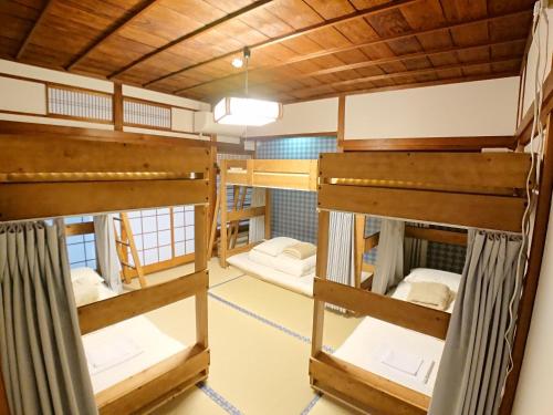 a group of bunk beds in a room at KINOSAKI KNOT in Toyooka