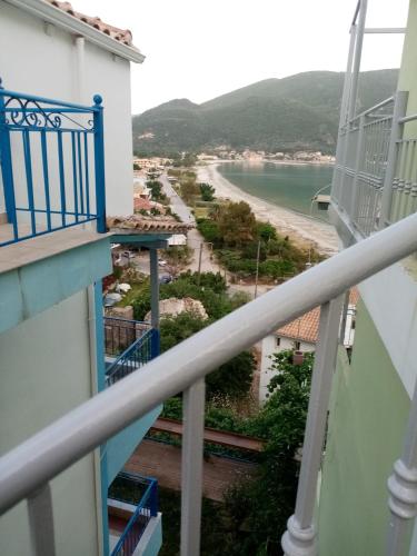 a view of the beach from the balcony of a building at Steven in Vasiliki