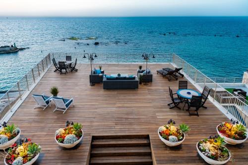 a deck on a cruise ship with a view of the ocean at Casa Nova - Luxury Suites & Boutique Apart-Hotel in Tel Aviv