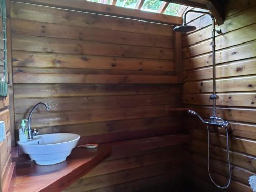 a bathroom with a tub and a sink at Les Bananes Vertes in Saint-Claude