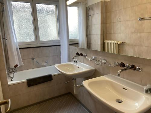 a bathroom with a sink and a bath tub at Serviced Apartments Haus 2 in Uzwil