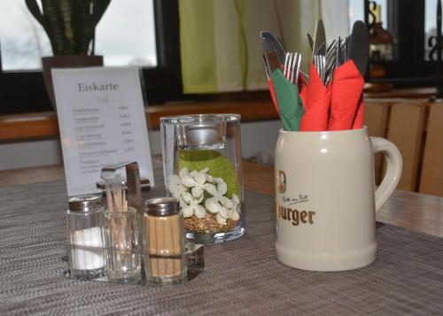 a table with a blender with a bunch of utensils at Gästehaus Zum Stehling in Monschau