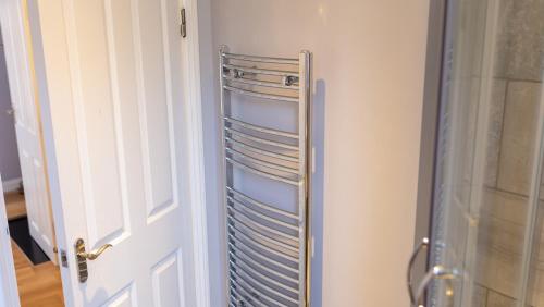 a refrigerator with a rack of dishes in a room at Church View Apartments in Weymouth