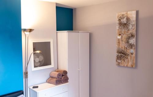 a room with a white cabinet and a picture at Church View Apartments in Weymouth