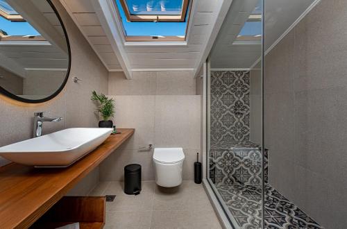 a bathroom with a sink and a shower at Horizon Apartments - Beachfront Luxury, by ZanteWize in Laganas
