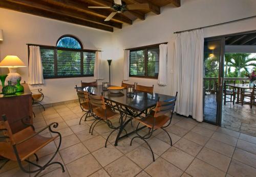 a dining room with a table and chairs at BELLAMARE in Virgin Gorda